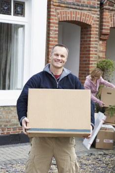 Small removals van loading furniture in Elmstead