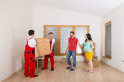 Packed boxes and furniture ready for flat removal in Elmstead