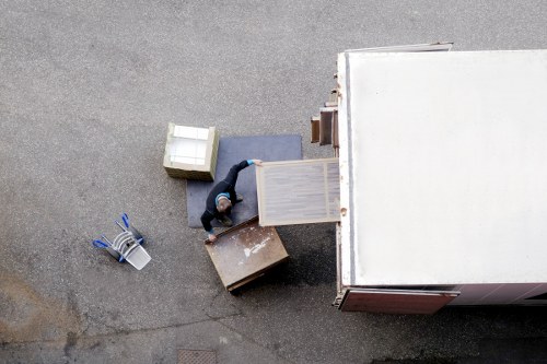Moving staff carrying belongings through a flat staircase in Elmstead